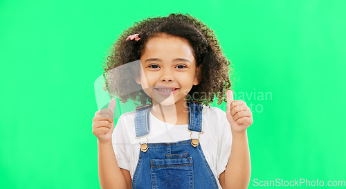 Image of Cute, green screen and face of a child with a thumbs up isolated on a studio background. Winning, success and portrait of a girl kid with an emoji hand gesture for motivation, yes and agreement