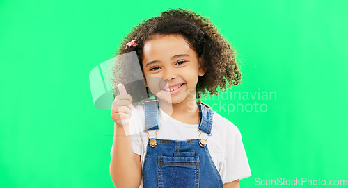 Image of Happy, green screen and face of a child with a thumbs up isolated on a studio background. Winning, success and portrait of a girl kid with an emoji hand gesture for motivation, yes and agreement