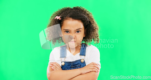 Image of Child, angry and face with arms crossed on green screen with attitude, problem or frustrated in studio. Black kid or girl with mad, grumpy and upset or annoyed facial expression with brat tantrum