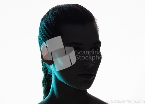 Image of Beauty, neon and silhouette with face of woman in studio for creative, glow or lighting mockup space. Fantasy, shadow and shine with female model on white background for art, disco and dark aesthetic