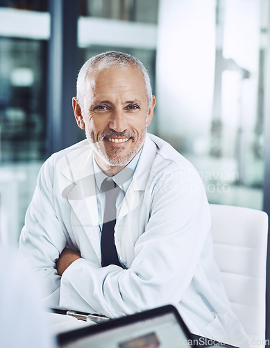 Image of Healthcare, portrait and senior doctor at desk with smile, pride and hospital management for support in clinic. Health care boss, happiness and medicine, happy man medical professional in office.