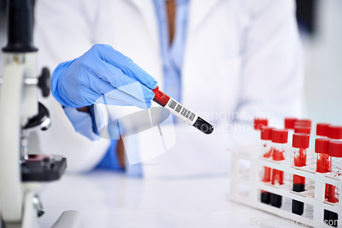 Image of Hand, blood and science with a doctor in a laboratory for dna research or innovation using a sample. Healthcare, medical and investigation with a scientist working in a lab for genetic analysis