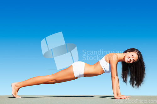 Image of Woman, pushup and fitness with healthy body, sky or happiness in mockup space, workout or sunshine. Girl, smile and plank for mock up, exercise or freedom for wellness, self care or underwear on roof