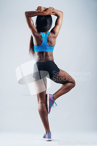 Image of Black woman, strong muscle and body with back in studio for balance, pose or training by white background. Isolated girl, model and bodybuilder for healthy workout with development, exercise or flex