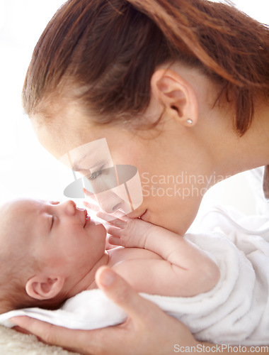 Image of Mother, kiss and newborn baby in closeup with love, happiness and care in bedroom at family home. Young mom, infant child and hug with happy bonding, pride and together on bed in morning at house