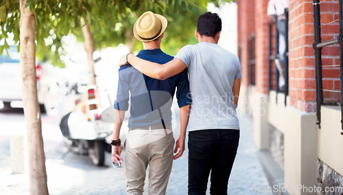Image of Travel, city and back of men walking in the road together while embracing on a tourism weekend trip. Affection, sightseeing and male friends in an urban street of a town on a holiday or vacation.