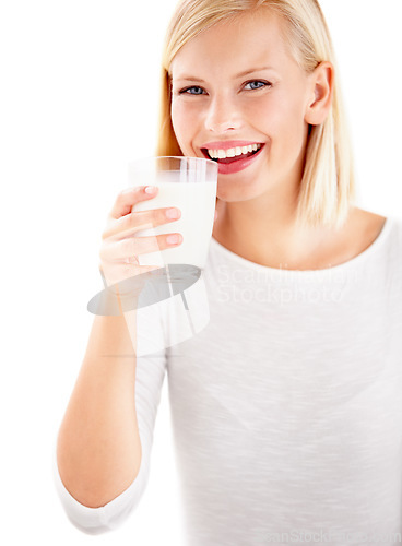 Image of Portrait, milk and smile with a woman drinking from a glass in studio isolated on a white background. Health, nutrition and calcium with a happy young female enjoying a drink for vitamins or minerals