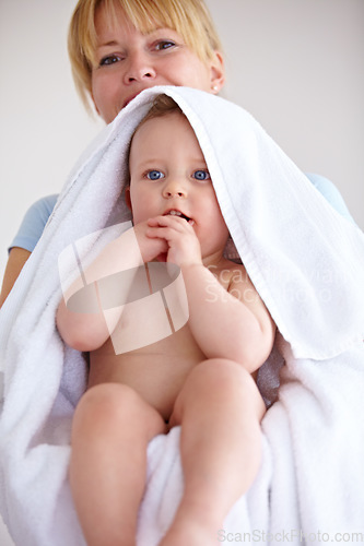 Image of Baby, towel and portrait with care for mother with comfort or love in a closeup or family home. Mom, hug and holding an infant for bath with cleaning or affection at house for hygiene with happy kid.