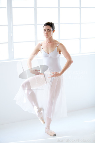 Image of Dance, ballet and creative with woman and practice studio for balance, elegant and performance. Artist, theatre and training with ballerina dancing in class for competition, freedom and commitment