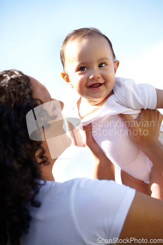 Image of Family, mother and baby outdoor in summer on a blue sky background with a mother lifting her infant daughter for flying. Love, kids and a mom holding her female child while bonding together in summer