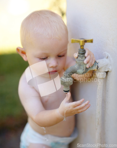 Image of Outdoor, water and a baby playing at a tap in a summer garden at home. Little kid, childhood growth and adorable infant boy curious about faucet, washing hands and getting wet in backyard of a house