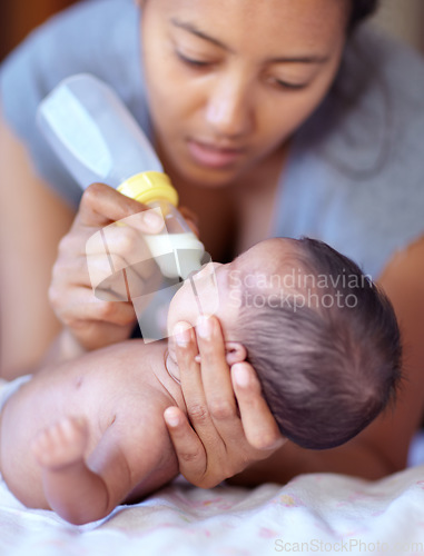 Image of Mother, baby and feeding milk from bottle for nutrition, health and wellness. Formula, newborn and mom feed child for early childhood development, growth and healthy diet, food and lunch at home.