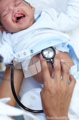 Image of Stethoscope, cleft palate and baby in medical exam and crying in a newborn hospital or clinic for healthcare. Doctor, pediatrician and infant child get cardiology test or check for care and health