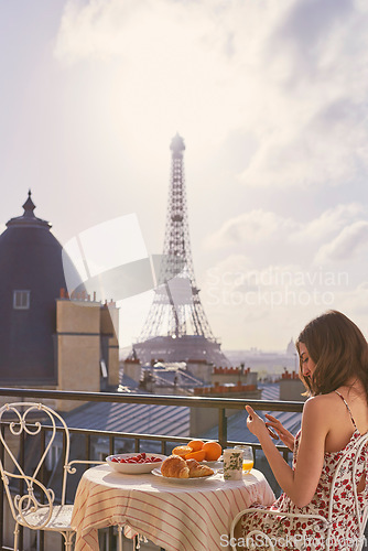 Image of Eiffel tower, breakfast and woman with a smartphone, typing and relax with connection, travel and social media. Female person, tourist and girl with a cellphone, Paris and tourism with food and view