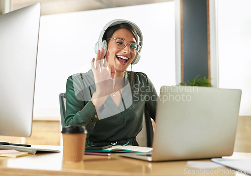 Image of Virtual meeting, business woman smile and wave on a video call with headphones and greeting. Laptop, working and employee with webinar at a company with computer and digital communication at office