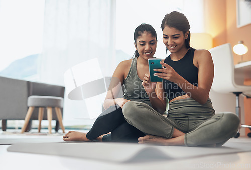 Image of Exercise, phone and women together at home with internet connection and social media. Indian sisters or female friends in lounge with smartphone for online class, chat or fitness workout with partner