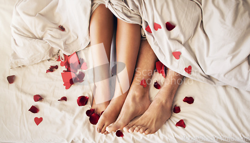 Image of Couple feet and heart in bed with love, valentines day and legs at home in morning. Bedroom, hearts and people with woman and man foot together in a house feeling romantic, relax and lazy on weekend