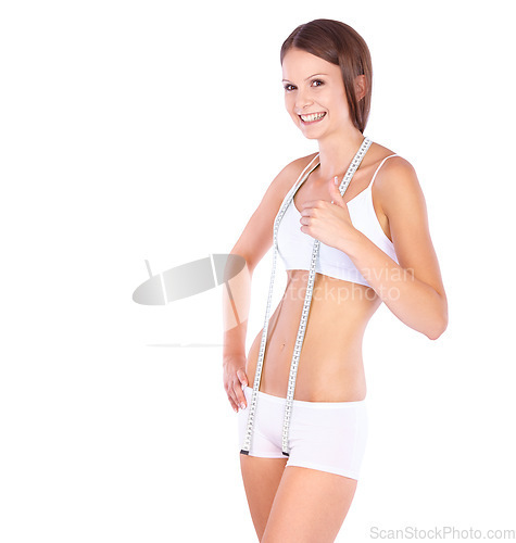 Image of Woman, measuring tape and studio portrait with thumbs up, weight loss success and fitness by white background. Isolated model, girl or underwear with diet goal, body or stomach for wellness with sign