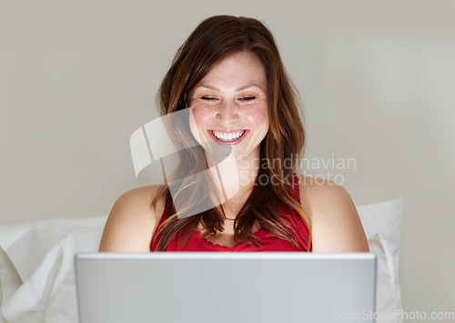 Image of Laptop, happy and woman on bed in home for social media, online search and email. Computer, bedroom and person smile on internet, reading blog or writing, typing and relax while streaming web video.
