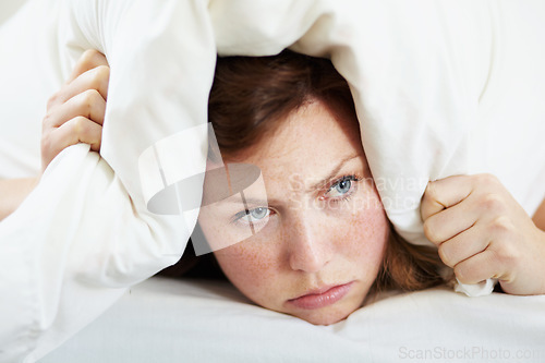 Image of Insomnia, noise and woman with pillow on ears to block loud sound, sleep fail and tired on bed in bedroom. Stress, person and covering head with cushion for problem, tinnitus and frustrated at night.