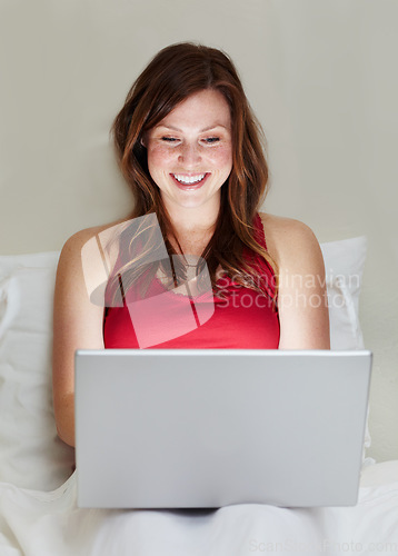 Image of Smile, laptop and woman on bed in home for social media, online search and email. Computer, bedroom and happy person on internet, reading blog or writing, typing and relax while streaming web video.