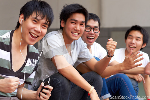 Image of Asian men, students and outdoor celebration for success, goal or sports with smile, happiness and fist. Japanese student group, celebrate or friends for winning, achievement or sport event at campus