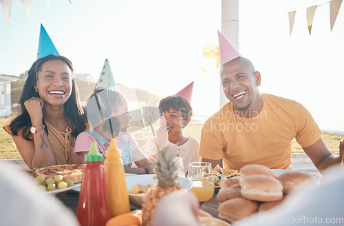 Image of Happy parents and children at birthday in park for event, celebration and party outdoors together. Family, social gathering and mother, father with kids at picnic with cake, presents and eating food