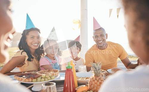 Image of Mother, father and children for birthday in park for event, celebration and party hat outdoors together. Family, social gathering and happy parents with kids at picnic with cake, presents and food