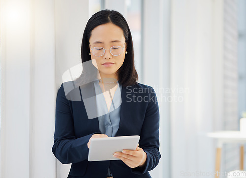 Image of Office, tablet and Asian business woman typing workplace report, online project feedback or analysis of corporate data. Professional administration, reading and person working in Japanese company HQ