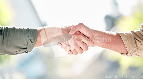 Image of Handshake, partnership and trust in care for support, retirement or agreement in deal, greeting or commitment. Hand of people shaking hands for love or teamwork together against a blurred background