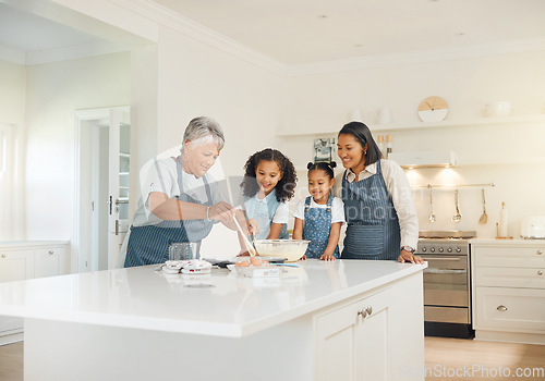 Image of Grandmother, mom or children baking as a happy family with girl siblings learning cookies recipe at home. Mixing cake, development or grandma smiling or teaching kid to help bake with eggs or flour