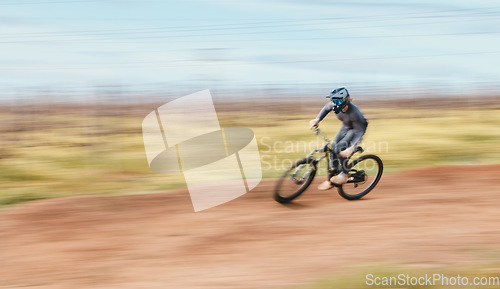 Image of Sports, blur and man riding a bike in nature training for a race, marathon or competition. Fitness, motion and male athlete biker practicing for an outdoor cardio exercise, adventure or workout.