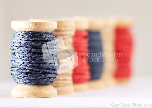 Image of Rolls, color or fashion with string, sewing or material production against white studio background. Empty, knitting industry or texture with textiles, crocheting or weaving with embroidery or fabric