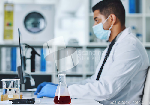 Image of Scientist man, computer and typing in lab for medical, pharmaceutical or covid research in face mask. Young male doctor, innovation and report on pc, check dna and science app for blood in laboratory