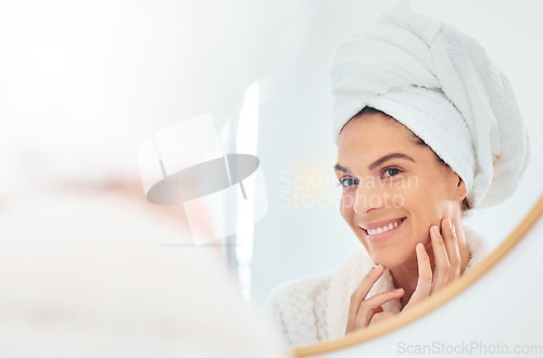 Image of Woman, mirror and hands on face for skincare, smile and anti aging cosmetic results in bathroom. Facial, beauty and female touching soft, glow and smooth skin after luxury dermatology routine at home