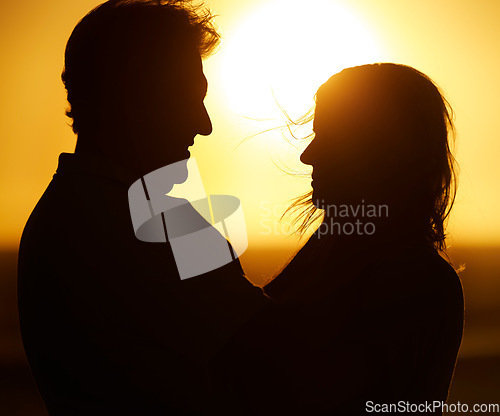 Image of Silhouette, couple and love at sunset on beach for vacation, holiday or adventure outdoor in nature. Romantic man and woman in marriage with sky background for care, shadow art and travel freedom