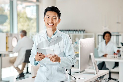 Image of Asian man, tablet and portrait of a scientist in laboratory, hospital or research for medicine, chemistry or innovation. Doctor, technology and medical worker with smile in clinic or science lab