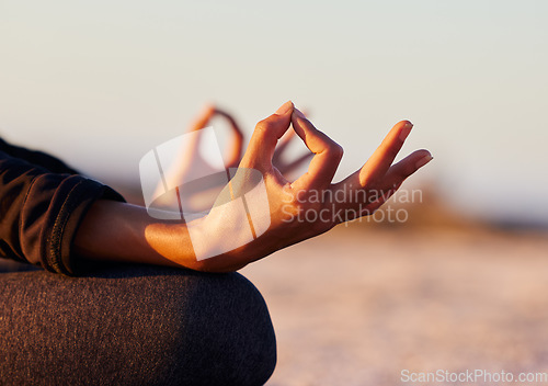 Image of Hands closeup, yoga and beach with woman, lotus and peace of mind in summer sunshine on sand. Girl, zen meditation and mindfulness for health, wellness or exercise by ocean, outdoor or chakra balance