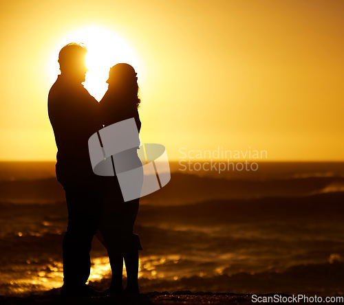 Image of Silhouette, couple and hug at sunset on beach for vacation, holiday or mockup outdoor. Romantic man and woman in nature with creative sky, space and ocean for love, shadow art and travel or freedom