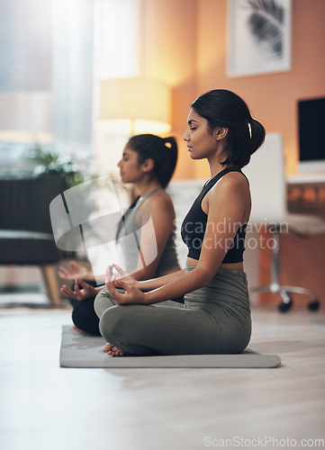 Image of Friends, meditation and zen women together in a house for mindfulness, health and relax wellness. Indian sisters or female family meditate in lounge for yoga, lotus and mental health balance at home