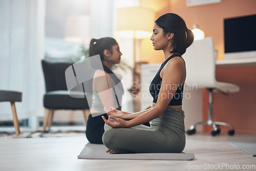 Image of Friends, meditation and women exercise together in a house with mindfulness, health and wellness. Indian sisters or female family meditate in a lounge for yoga workout, lotus and fitness with partner