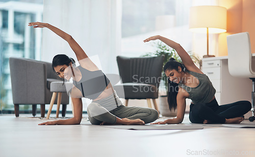 Image of Women, yoga exercise and friends together in a house with happiness, health and wellness. Indian sisters or female family on lounge floor for stretching workout, balance and fitness with partner