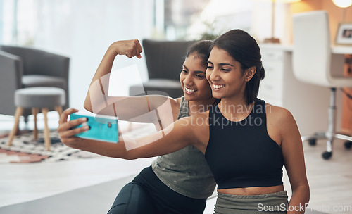 Image of Fitness, friends and strong muscle selfie of women together at home for social media memory or post. Indian sisters or female family with photo for influencer update, workout motivation or results