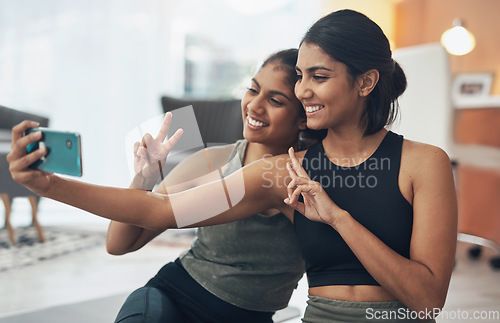 Image of Fitness, peace sign and selfie of women together at home for social media memory or post. Indian sisters or female friends with photo for influencer update, workout motivation or hand for happy emoji