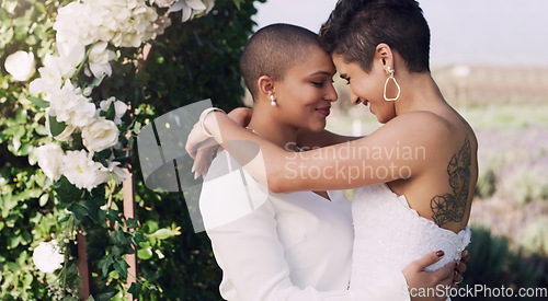 Image of love, hug and kiss with lesbian couple at wedding for celebration, gay and pride. Smile, spring and happiness with women at marriage event in garden for partner commitment, lgbtq and freedom