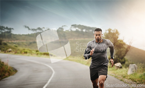 Image of Man, road running and space in nature for exercise mockup, wellness or music with commitment for health. African male runner, listening and audio for focus, mindset and mock up with workout on street