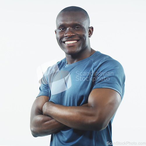 Image of Black man, smile and portrait with strong arms crossed and confidence in a studio. White background, African male person and happy model face with pride, active style and fitness fashion isolated