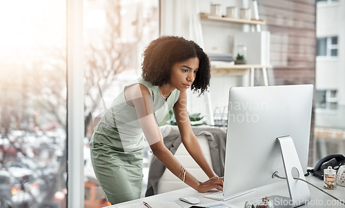 Image of Computer, schedule and woman planner typing and working by her desk or table in a corporate startup company. African, business and professional female employee or personal assistant planning project