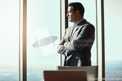 Image of Business man, office window and thinking of ideas, plan or vision in city building. Professional male executive with arms crossed for motivation or inspiration for corporate career and development