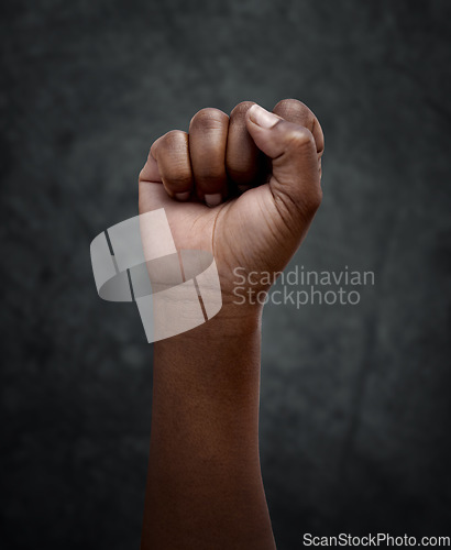 Image of Equality, protest and hand fist for justice or solidarity, human rights and support for the community. Fight for change, power. and revolution for freedom or empowerment on dark or black background